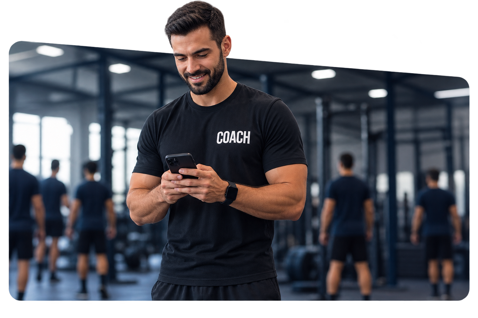 Coach in a COACH T-shirt checking the challenge leaderboard on his phone in the gym